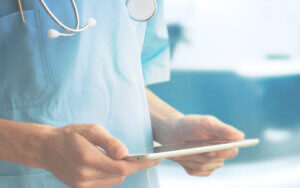 healthcare worker holding an ipad